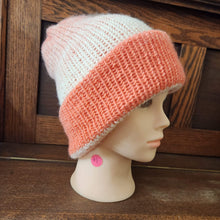 beanie hat in colors going from coral to white 