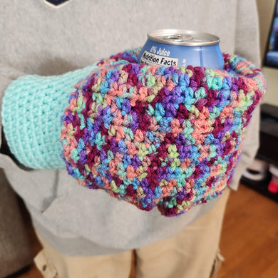 hand knit mitten with closed bottom which is used to hold a cold can in the winter.  variegated colors from light blues to maroon