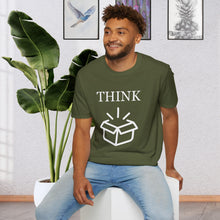 a man sitting on a stool in front of a plant wearing a Military Green T-Shirt that says the Word Think in white ink above a picture of an open box which is also white.