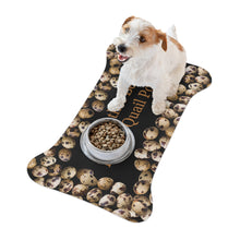 A cute dog sitting by a bowl on a feeding mat is shaped like a bone and has a unique design with quail eggs arranged around the outer edges. The center of the mat features the text "I would rather be eating quail poo"