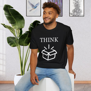 a man sitting on a stool in front of a plant wearing a Black T-Shirt that says the Word Think in white ink above a picture of an open box which is also white.
