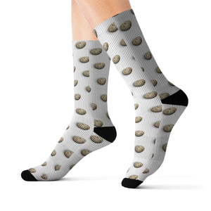 a pair of socks with Coturnix Quail eggs on them.  They have black heals and toes with a cushioned bottom