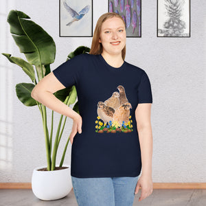 A girl wearing a Navy Blue T-shirt. This is a unique and stylish piece of clothing that features a beautifully detailed illustration of a Coturnix Quail. The illustration is printed in a natural brown hue, giving the shirt a rustic and earthy feel with colorful flowers.