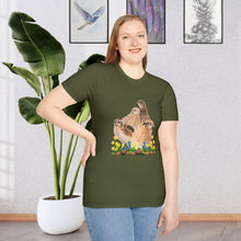 A  girl wearing a Military Green T-shirt is a unique and stylish piece of clothing that features a beautifully detailed illustration of a Coturnix Quail. The illustration is printed in a natural brown hue, giving the shirt a rustic and earthy feel with colorful flowers.
