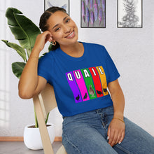 A girl seated in a chair by a plant wearing a Royal Blue T-Shirt features multi-color verticle stripes in Purple, Pink, Green, Red, and Yellow. Each vertical stripe has a letter of the word quail at the top, It has silhouettes of Coturnix Quail, along with one in full color that is standing tall in the center of the graphic.