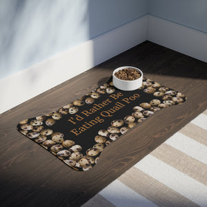 A dog feeding mat is shaped like a bone and has a unique design with quail eggs arranged around the outer edges. The center of the mat features the text "I would rather be eating quail poo"